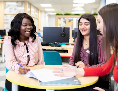 A group of managers sit around a table. 