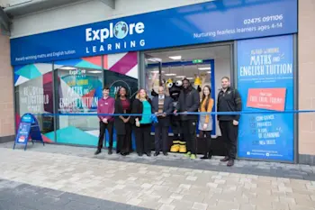 Staff outside an Explore Learning branch smiling