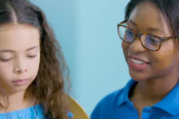 A tutor helping a child learn