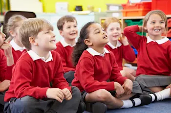 Primary school children sat on the floor for assembly