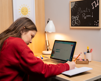 A girl working during her online tuition lesson with Explore Learning