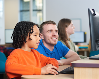 Tutor supporting a child with SATs preparation in an Explore Learning centre