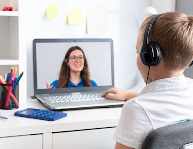 A young boy doing an online maths and English tuition session with an Explore Learning tutor.