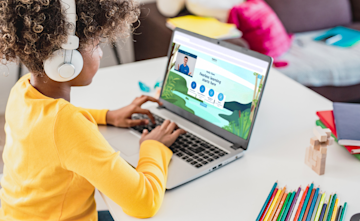 Young girl taking part in an online tuition session with an Explore Learning tutor using our smart learning tool.